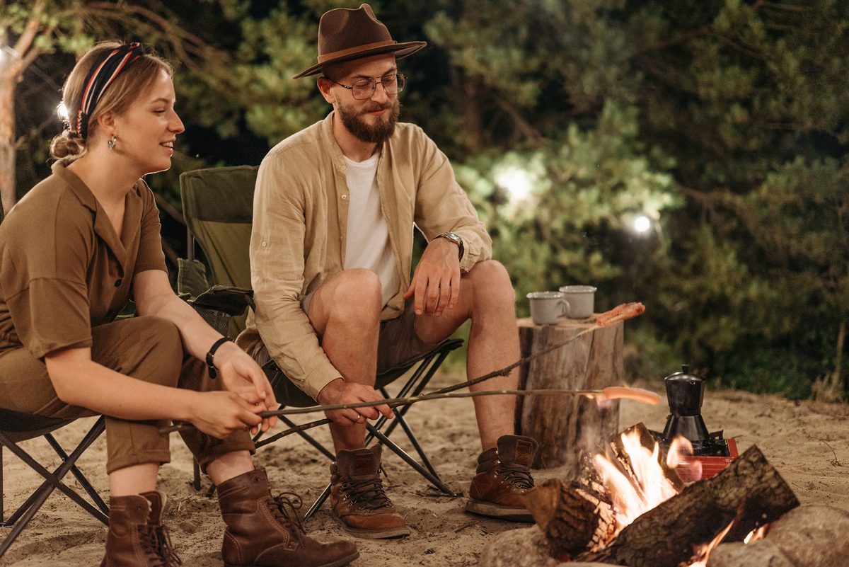 Campfire glowing at dusk in an outdoor camping setting